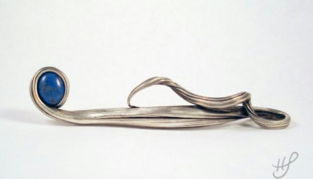 Pendant that looks like a waterfall flowing into a blue pool with a denim lapis stone.