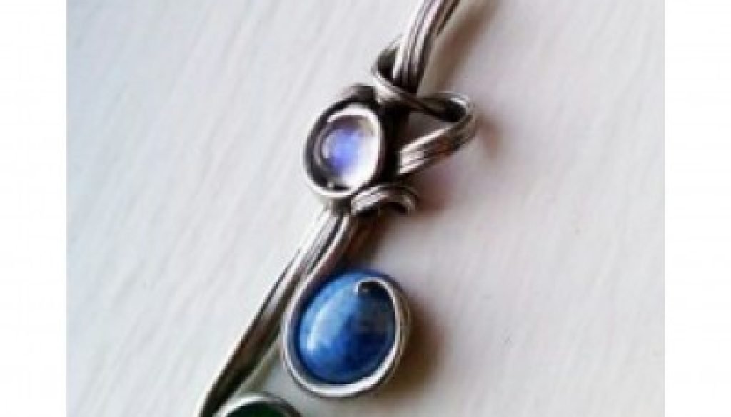 Pendant with a rainbow moonstone, denim lapis blue stone, and a green stone.