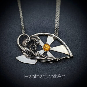 Sculptural wave necklace with a sun behind the waves and a citrine stone in the center of the sun.
