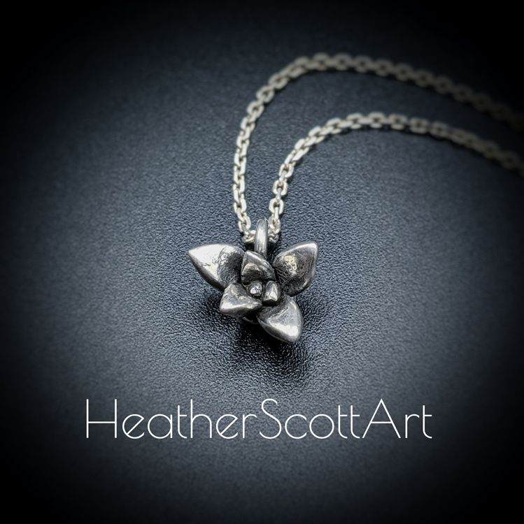 Small Silver Succulent Pendant with Pointed Leaves on a Silver Chain.