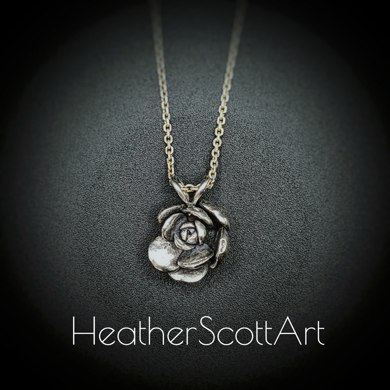 Silver Succulent pendant with rounded petals hanging on a silver chain against a black background with the words Heather Scott Art in the foreground.