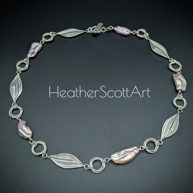 Sterling silver necklace with mitsuro links, round triple links, and pink Edison pearl links alternating. Sitting on a black background with the words Heather Scott Art in the foreground.