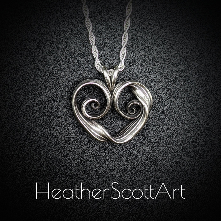 Sterling Silver heart with twisting sides.